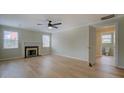 Bright living room features beautiful hardwood floors, a fireplace, and an entrance to the bathroom at 4131 Carroll Sw St, Covington, GA 30014