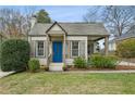 Inviting one-story home featuring a quaint front porch and a bright blue front door at 49 Wyman Se St, Atlanta, GA 30317