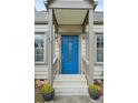 Welcoming front door with blue paint, decorative glass, and flower planters, enhancing curb appeal at 49 Wyman Se St, Atlanta, GA 30317