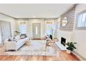 Bright living room with a decorative fireplace, hardwood floors, and stylish neutral decor at 49 Wyman Se St, Atlanta, GA 30317