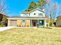 Attractive two-story home featuring a manicured front lawn and attached garage at 6242 Marbut Farms Ln, Lithonia, GA 30058