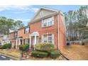 Attractive two-story brick townhouse with blue shutters and a well-maintained lawn at 1976 Drennon Ave, Austell, GA 30106