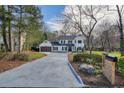 Beautiful two-story home featuring a long driveway, modern garage, and well-maintained landscaping at 3090 Maple Ln, Alpharetta, GA 30009