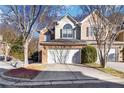 A well maintained townhome features a two-car garage and a manicured lawn at 3263 Tomeh Way, Tucker, GA 30084