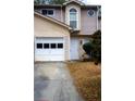 Charming townhome with a one car garage and a well-maintained front entrance and established landscaping at 3736 Soapstone Rd, Decatur, GA 30034