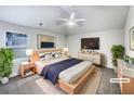 Bright staged main bedroom with lots of natural light and comfortable, modern decor at 405 Sora Dr, Stockbridge, GA 30281