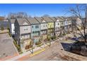 Beautiful row of colorful townhomes with street lamps and sidewalks at 68 Adore Se Ct, Atlanta, GA 30315