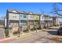 Charming townhome row showcasing colorful facades, balconies, street lamps and sidewalks at 68 Adore Se Ct, Atlanta, GA 30315