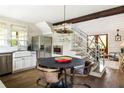 Bright kitchen featuring stainless steel appliances, wooden floors, and a farmhouse sink at 1015 Loliver Ln, Chattahoochee Hills, GA 30268