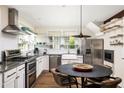 Well-lit kitchen showcases modern appliances, custom shelving, and a functional dining space at 1015 Loliver Ln, Chattahoochee Hills, GA 30268