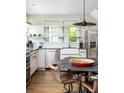 Stylish kitchen displays sleek appliances, open shelving, and a charming farmhouse sink area at 1015 Loliver Ln, Chattahoochee Hills, GA 30268