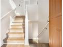Bright entryway showcasing hardwood stairs, white walls, and modern fixtures, leading to the home's interior at 1534 Norman Xing, Atlanta, GA 30349