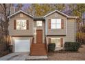 Charming two-story home featuring a well-maintained lawn, neutral siding, and classic shutters at 1534 Norman Xing, Atlanta, GA 30349
