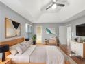 A spacious bedroom featuring a tray ceiling and hardwood floors at 155 Mine Run, Fayetteville, GA 30215