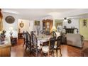 Open dining room with hardwood floors, a decorative hutch, and access to a cozy living room at 3948 Bright Star Rd, Douglasville, GA 30135