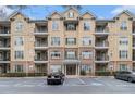 A stately condo building features a meticulously maintained facade and well-manicured landscaping at 2201 Stratford Commons, Decatur, GA 30033