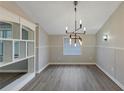 The dining area includes a modern chandelier and wainscotting at 2236 Brannen Se Rd, Atlanta, GA 30316