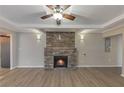 Spacious living room boasts a stone fireplace, modern lighting, and hardwood floors at 2236 Brannen Se Rd, Atlanta, GA 30316