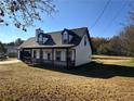 Charming two-story home with covered porch, dormer windows, and attached garage at 1350 Cedars Rd, Lawrenceville, GA 30045