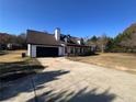 Home exterior showcasing attached garage, dormer windows, and long driveway at 1350 Cedars Rd, Lawrenceville, GA 30045