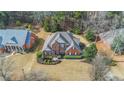 A high aerial view shows the home, well-maintained landscaping, and surrounding neighborhood at 1027 Eagles Brooke Dr, Locust Grove, GA 30248
