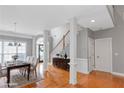 Elegant dining room with decorative pillars, hardwood floors, and a large window for natural light at 1027 Eagles Brooke Dr, Locust Grove, GA 30248