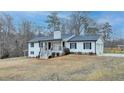Beautiful two-story home with a charming front porch and a lush green yard at 2885 Green Rd, Loganville, GA 30052