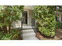 Inviting entrance to the townhome, showcasing a well-maintained exterior and manicured greenery at 1202 Charleston Ct Cir, Woodstock, GA 30188