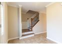 Inviting foyer with tiled floors and a staircase featuring wooden rails and iron spindles at 2812 Lake Vista Dr, Buford, GA 30519