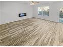 Spacious living room displaying gorgeous wood-look floors and a modern fireplace feature at 3972 Carlinswood Way, Stone Mountain, GA 30083