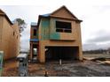 Two-story house under construction featuring an attached two-car garage and a modern, open floor plan at 1975 William Glen St, Dacula, GA 30019