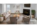 Bright, staged living room features neutral furniture, fireplace, and stylish decor at 61 Barrington Pl, Marietta, GA 30066