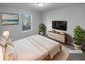 Bright primary bedroom with a large window and neutral decor for relaxation at 61 Barrington Pl, Marietta, GA 30066