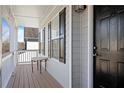 Inviting front porch with wood flooring and white pillars, leading to the front door at 4085 Amberly Nw Grn, Kennesaw, GA 30144