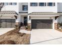 New townhome with white brick, black door and a attached garages at 704 Dodd Ln # 158, Buford, GA 30518