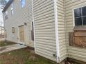 Back exterior shows siding, boarded windows and door with scattered glass at 6357 Polar Fox Ct, Riverdale, GA 30296