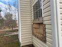 Close up of house siding and boarded up window at 6357 Polar Fox Ct, Riverdale, GA 30296