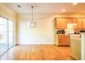 Eat in kitchen with light yellow walls and wood floors at 485 Lantern Wood Dr, Scottdale, GA 30079