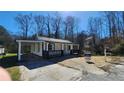 Charming home with a covered front porch and a convenient carport at 2322 Ewing Sw St, Atlanta, GA 30331