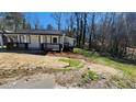 A quaint white home with black trim on a lot with sparse grass at 2322 Ewing Sw St, Atlanta, GA 30331