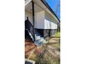 Exterior side view of a house with access stairs and dark trim at 2322 Ewing Sw St, Atlanta, GA 30331