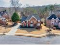 An elevated view showing the brick home, mature trees, and well-maintained landscaping at 1677 Angelica Ct, Lawrenceville, GA 30043