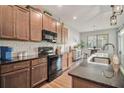 Modern kitchen with stainless steel appliances, granite countertops, and wood cabinetry at 24 Aspen Way, Dallas, GA 30157