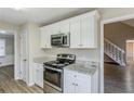 Kitchen with white cabinets, granite countertops, stainless steel appliances and an oven range at 3225 Redona Dr, Atlanta, GA 30349