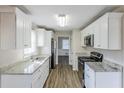 Galley kitchen featuring white cabinets, granite counters, and stainless steel appliances at 3225 Redona Dr, Atlanta, GA 30349