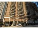 High-rise apartment building with multiple balconies and street access on a sunny day at 620 Peachtree Ne St # 502, Atlanta, GA 30308