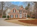 Beautiful two-story brick home with black shutters and well-maintained landscaping at 1355 Zephyr Ct, Cumming, GA 30041