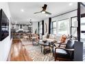 Stylish living room featuring a modern ceiling fan and large windows overlooking the yard at 2047 Seavey Dr, Decatur, GA 30032