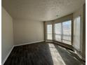 Spacious living room filled with sunlight from large windows and featuring stylish wood-look tile flooring at 225 Whirlwind Ct, Atlanta, GA 30349