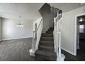 Inviting foyer features a staircase with white railings and wood-look tile flooring throughout the entryway at 225 Whirlwind Ct, Atlanta, GA 30349